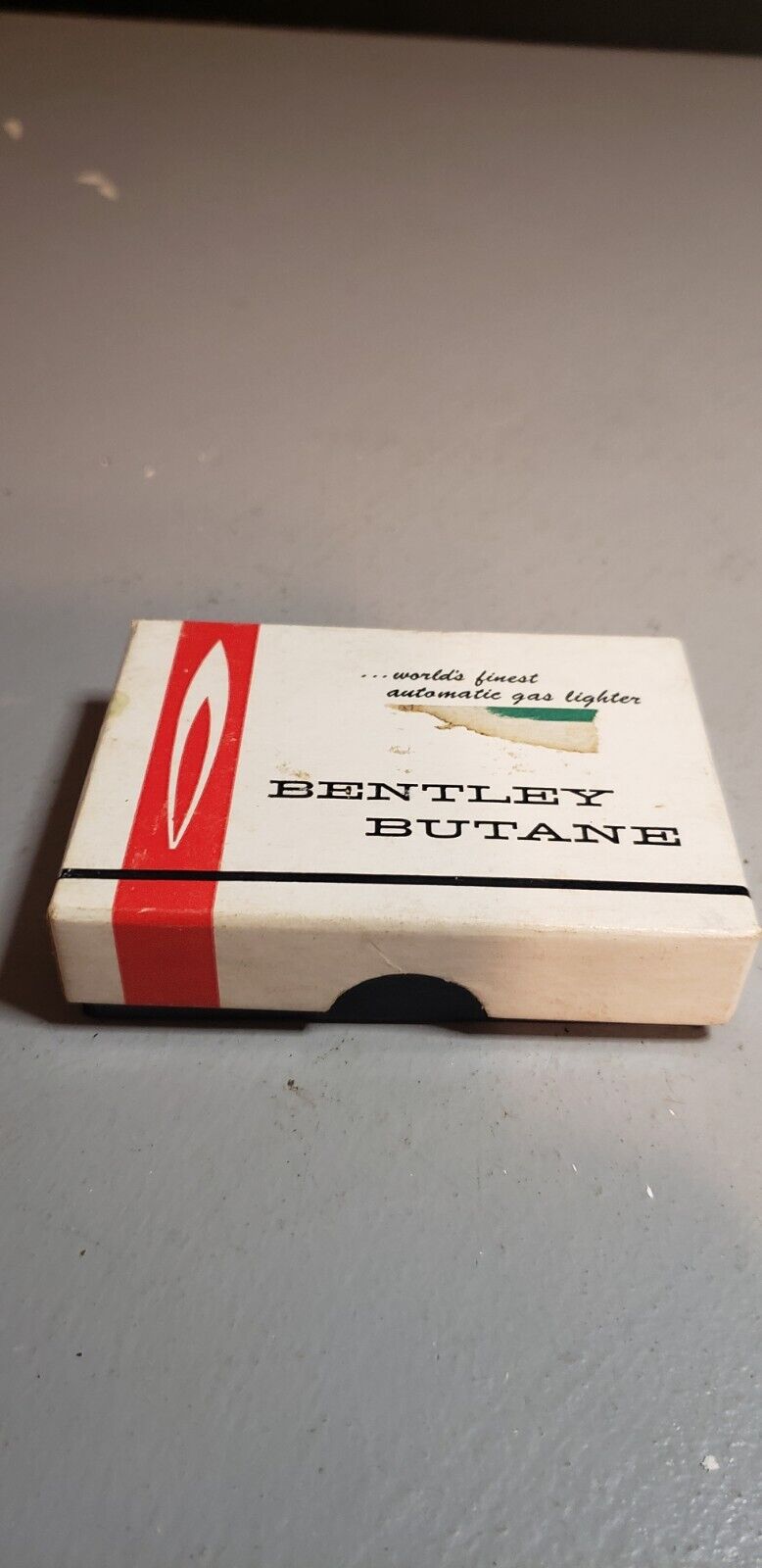 Bentley Butane Lighter in original box. never been struck, lines, needs some tlc